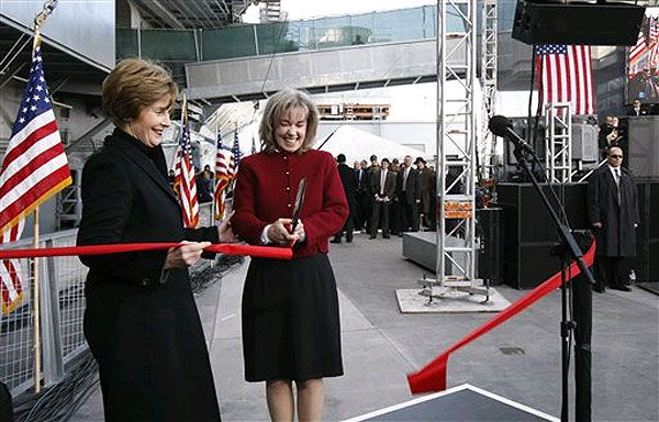 First lady Laura Bush and Sally Hoover Casale, granddaughter of the original dedicators of the U.S.S. Intrepid, cut the ribbon during the rededication ceremony